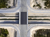 A birds-eye view of the canal going under the Eko Boulevard bridge. The roads on the top and bottom of the image allow drivers to access the expressways that will be built on each side of the canal.
