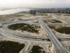 An aerial view of the road network in Eko Atlantic. The roads in this image can be seen going over the canal, around the canal, and descending to the canal