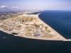 A view of Eko Atlantic facing east. The large circular road towards the middle of the image will be the ring road that surrounds the Marina District. The image also shows towards the left, Alpha 1 tower, the middle, Eko Pearl Towers, and the right, Azuri Peninsula Towers.