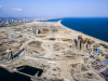 A view of Eko Atlantic facing east. The large circular road towards the middle of the image will be the ring road that surrounds the Marina District. The image also shows towards the left, Alpha 1, the middle, Eko Pearl Towers, and the right, Azuri Peninsula Towers.