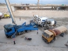 Concrete Trucks loading contrcrete into the mobile pneumatic pump to cast a bridge.